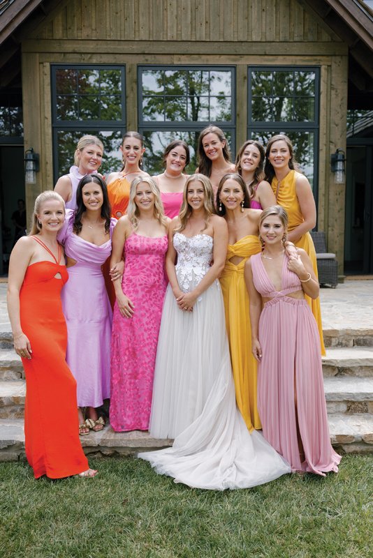 The bride with her bridesmaids in pretty fall florals.