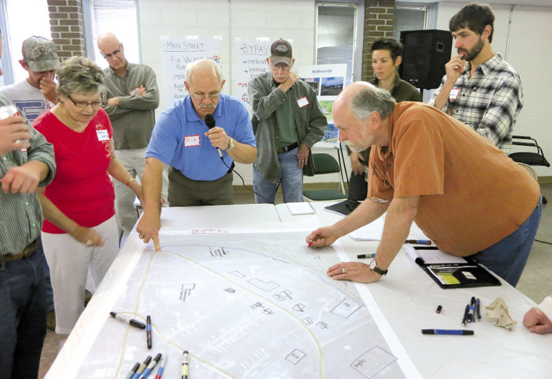 Community members, including Rick Davis (center) and Brenda Artiss (left) share their thoughts during a design meeting.