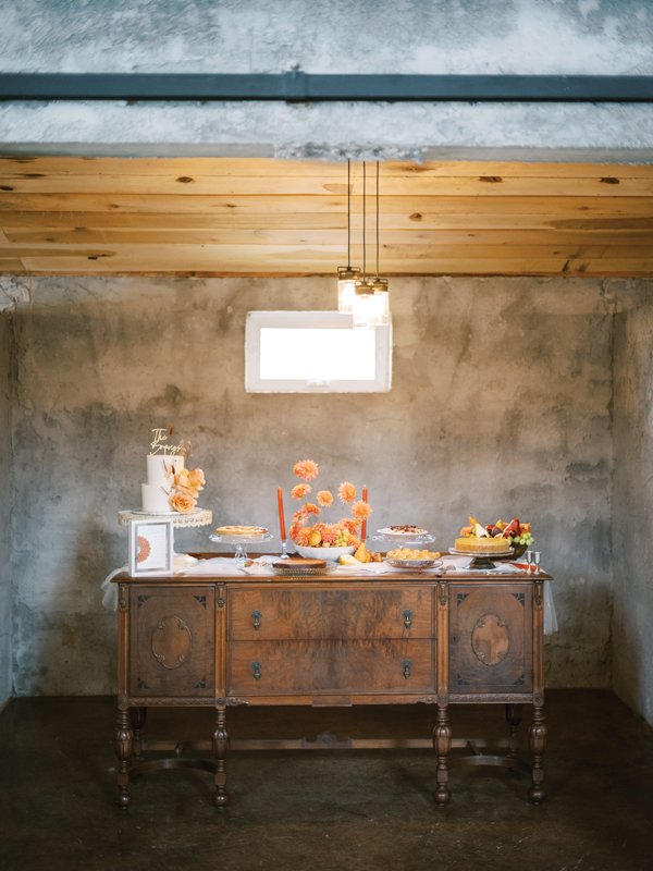 An antique buffet warmly invites guests to choose from a selection of favorite desserts.