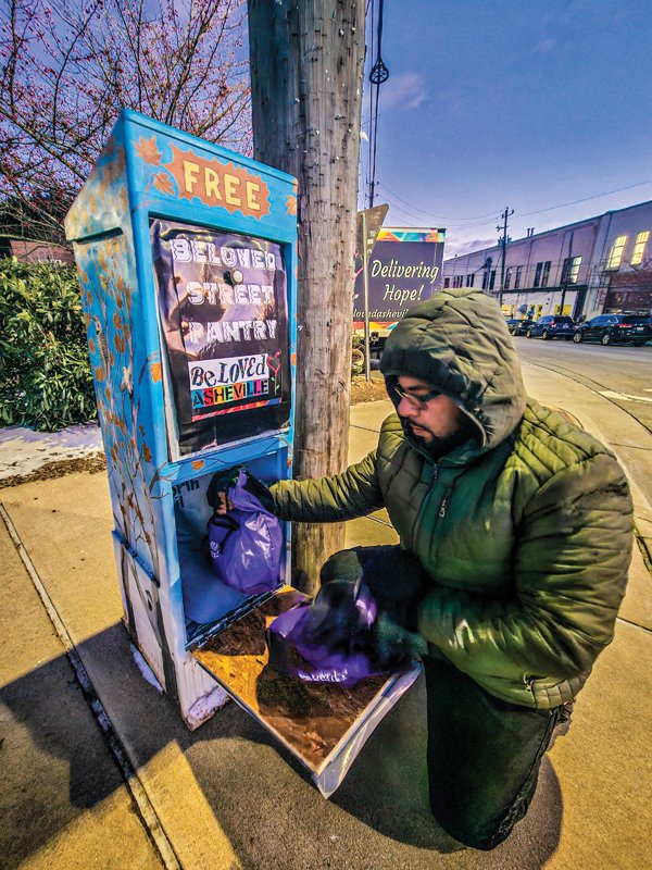 Ponkho Bermejo drops off food at one of BeLoved Asheville’s Street Pantries