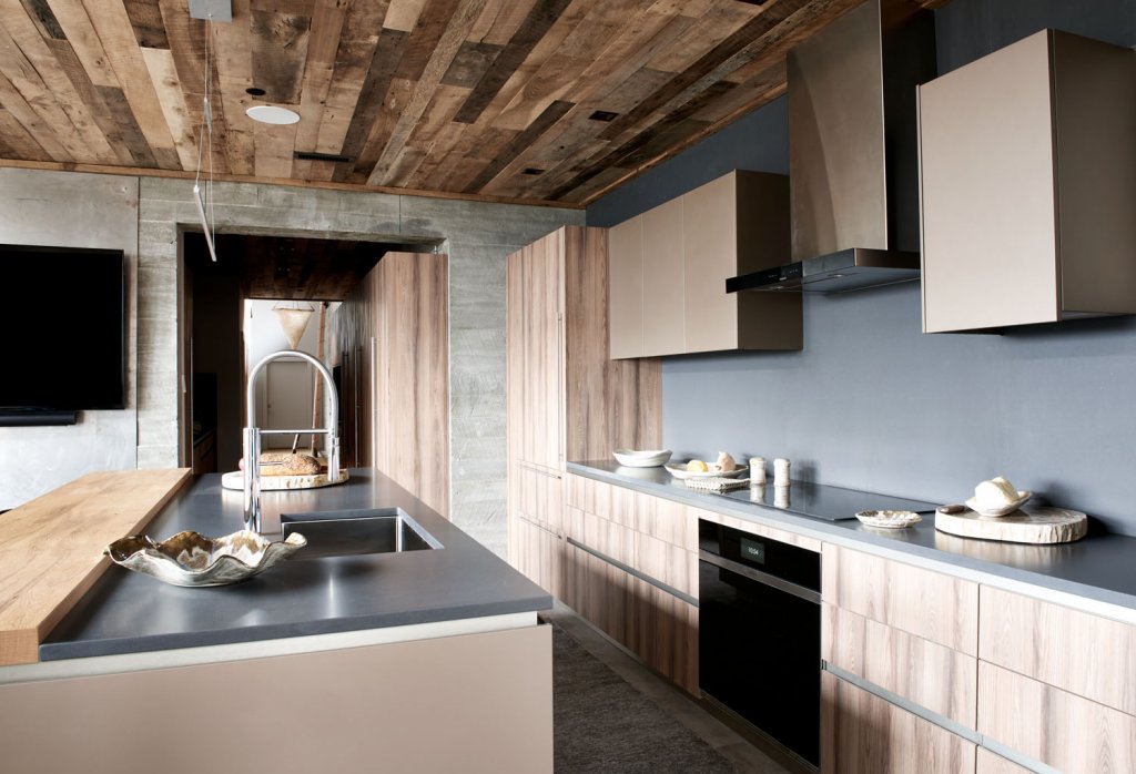 The ceilings are adorned with reclaimed wood in a darker shade than the bamboo hues found throughout the home.