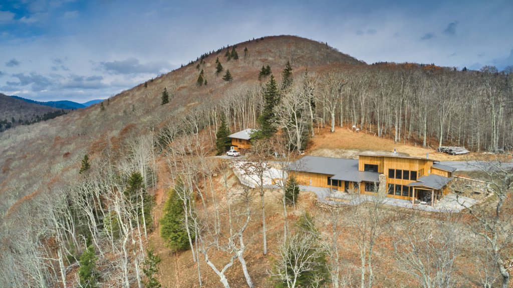 The home rests at the very top of a Maggie Valley mountain, overlooking the Blue Ridge in quiet isolation.