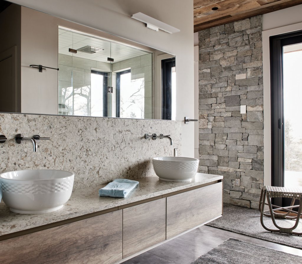 In the bathroom, hand-selected stoneware accents keep the room feeling natural yet solid.