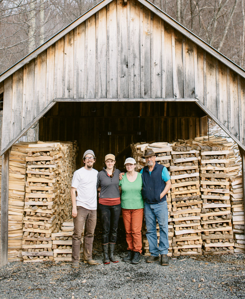 From left, Michael Waldeck, Wheeler Munroe, Nancy Roten, and Doug Munroe work as a team to produce maple syrup at Waterfall Farm.