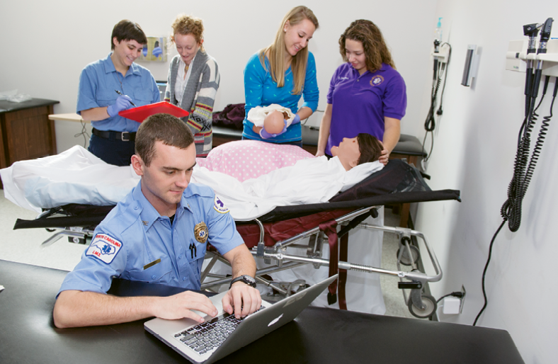 Practice makes perfect: The program’s paramedic students conduct their studies in settings meant to mimic real-life  conditions.