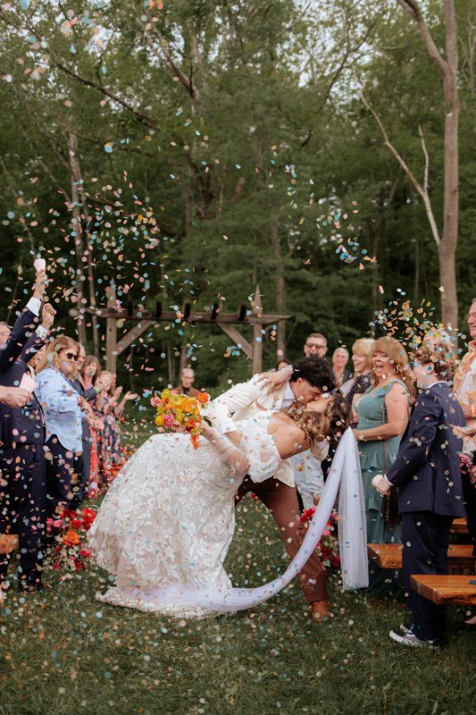 Evy Linkous and Andrew Brassinga enjoy a kiss down the aisle.