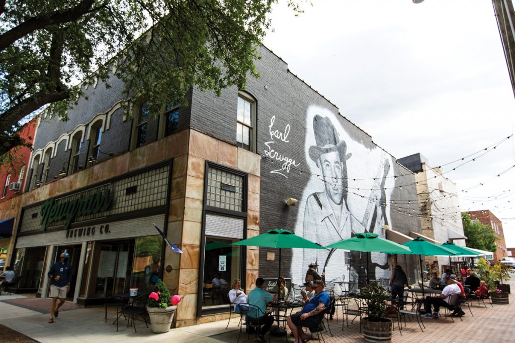 Shelby honors its country legends like Scruggs and Don Gibson with a mural downtown.