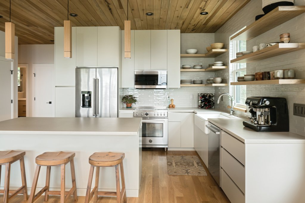 White oak adorns the windowsills, while matching shelving and white oak tractor stools tie the wooden elements together. The home gets its dinnerware from the East Fork Pottery collection, which includes older hand-thrown pieces and a 12-piece dining setting.