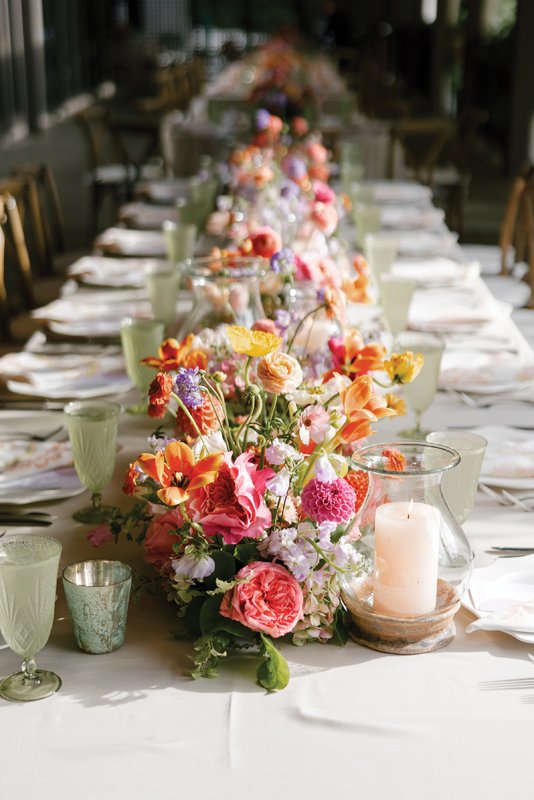 Family-style seating with low, flowing centerpieces facilitate easy conversation between guests.