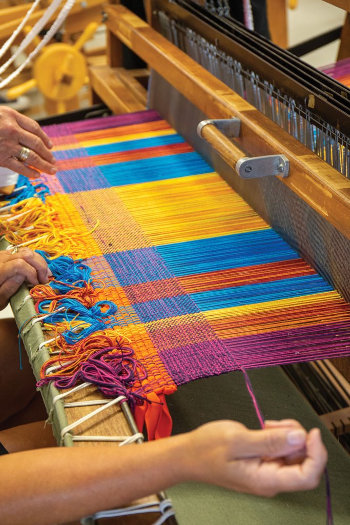 Students learn by doing, such as weaving.