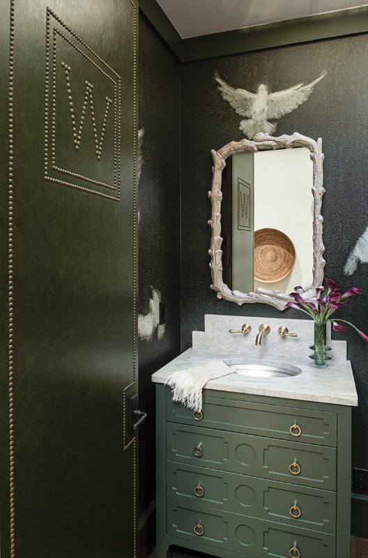 The bathroom features striking hues of sage.