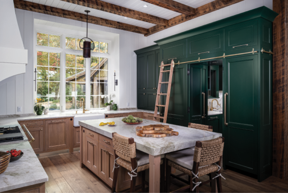 In the kitchen, a stretch of dark green cabinets echoes the range’s British racing green. The oak rolling ladder is for Maribeth, who, “spends some part of every day standing or kneeling on counters to reach something.” With the ladder, she can reach the tallest cabinets, making use of all the storage options in the home.