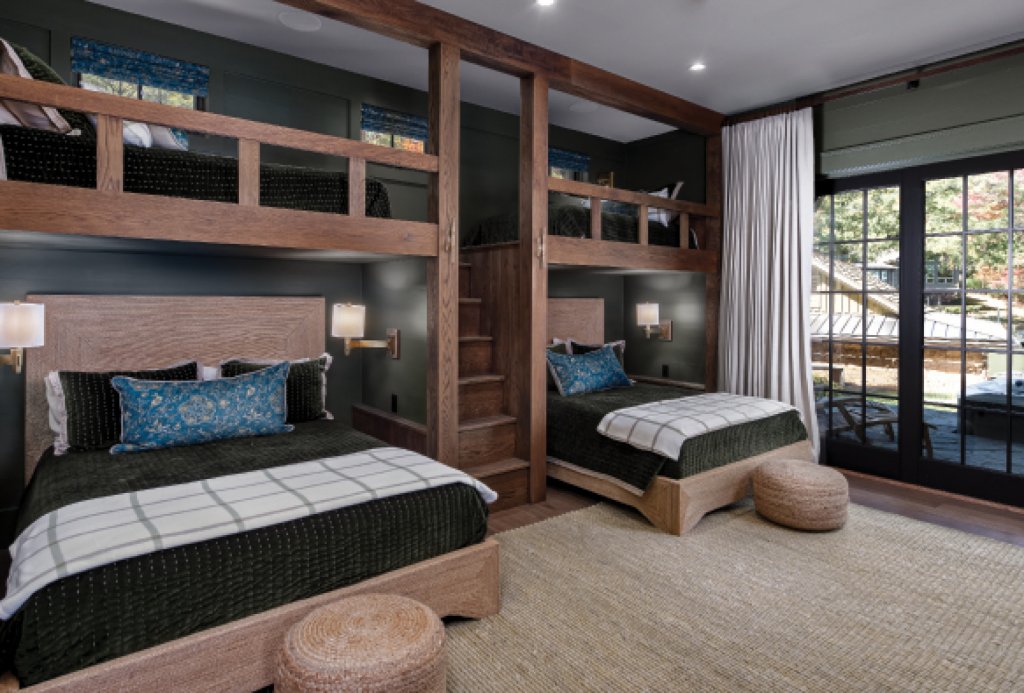 In a sophisticated take on a bunk room, built-in twin bed lofts hover over queen beds to offer plenty of space for overnight guests.