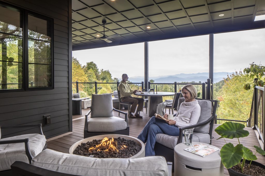 Outdoor Spaces - The Williams’s back porch overlooks the stunning Appalachian Mountains in the heart of Western North Carolina. A dining table and chairs, a firepit, outdoor lounge furniture, and more all make the most of the spacious wrap-around porch.