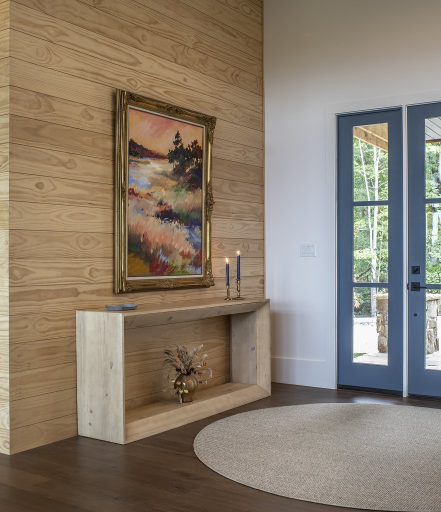 Eye Candy - In the entryway, a colorful painting draws the eye amidst a neutral wooden brown palette.