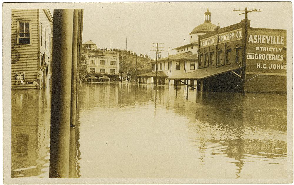 On Asheville’s riverside South Depot Street, the Southern Railway Station, streetcars, and a grocery were swamped.