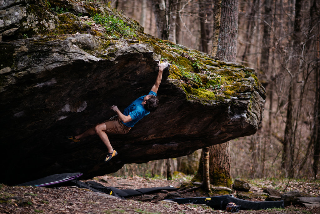 HONORABLE MENTION - LEAP - Andy Wickstrom - Asheville climber Josh Cooper on Corner Rock boulder outside of Barnardsville. Professional category