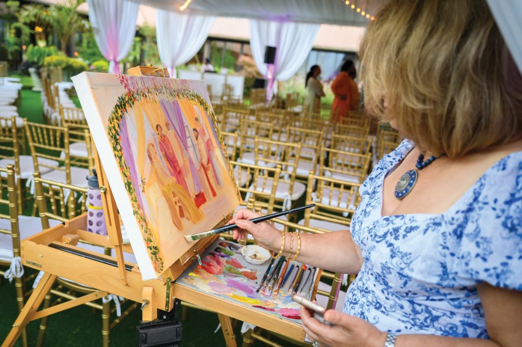 A painter captures the colorful wedding day live.