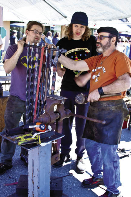 Blacksmith Scott Lankton (right) with Atticus McFaddem-Keesling (left) and Lewis Body
