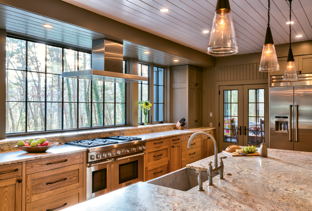 The kitchen remodel to update and add square footage was extensive. In an effort to keep some of the home’s historical integrity, original chestnut paneling was repurposed to build the lower cabinetry.