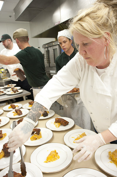 Chef Jesse Roque plating her sticky sweet potato Thai potion-drenched baby back ribs.