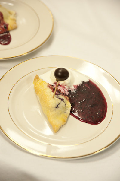 Baked blueberry cream cheese turnover with vanilla ice cream, blueberry caramel sauce, and chocolate-covered blueberry prepared by chef Charles Hudson and the Sunburst Trout Farms team.
