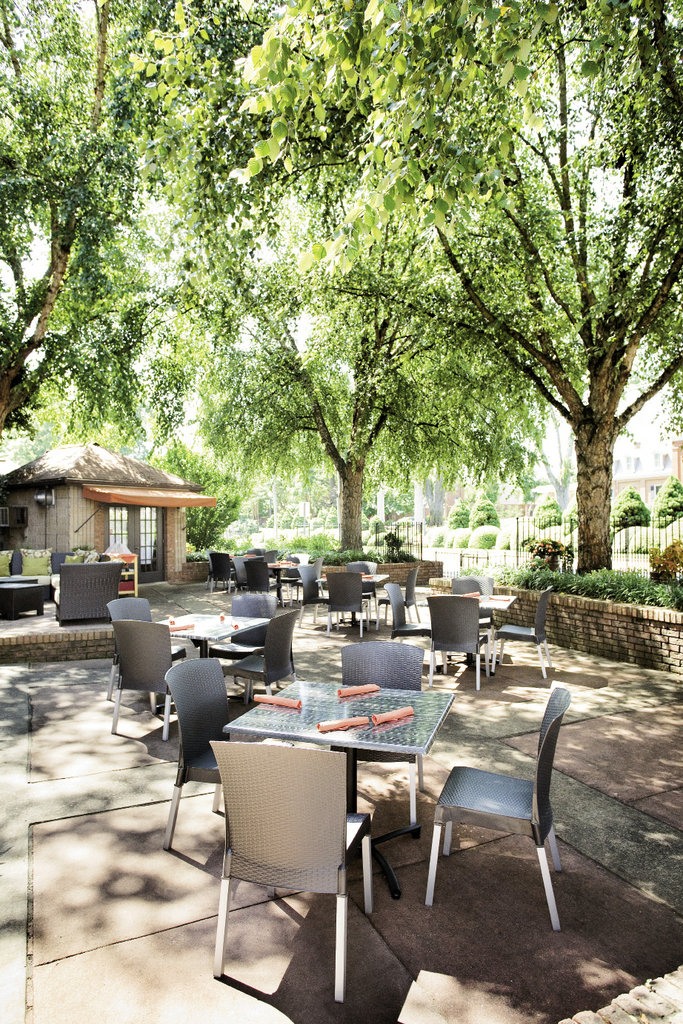 the spacious patio is a sophisticated spot for lunch, dinner, or cocktails, such as the Cool Cucumber martini.