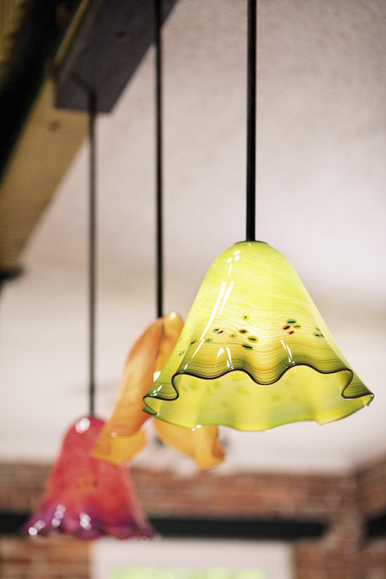 Objects by local artisans accent the home, including colorful glass pendant lamps crafted by Sam Stark.