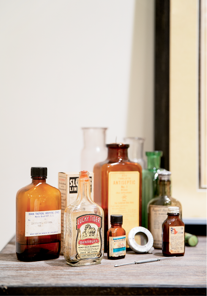 Old medicine bottles add intrigue to a shelf in the guest bathroom.