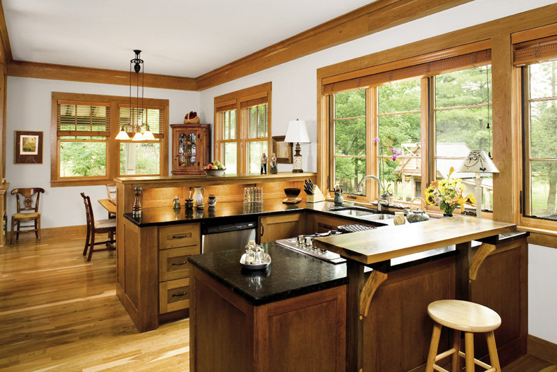 Banks of windows bathe the kitchen and dining room in sunlight.