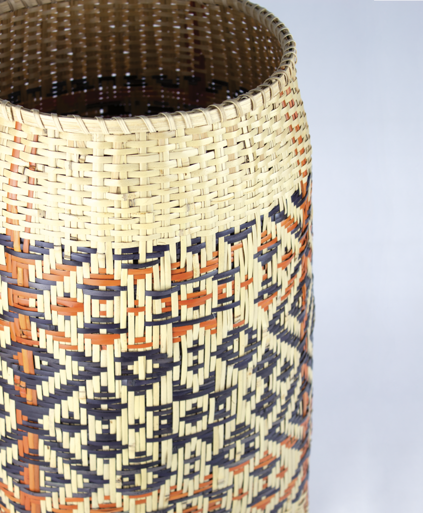 A rivercane basket with butternut and bloodroot dyes by Ramona Lossie. Lossie&#039;s work was featured in the Center for Craft&#039;s summer exhibit &quot;Weaving Across Time,&quot; a collection of nine contemporary Cherokee basketmakers who explored the boundaries of this centuries-old medium through size and materials. Although this exhibit ended in June, the Center hosts exhibits year-round.