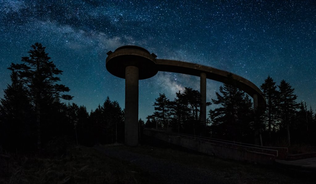 Clingmans Dome - For stargazers willing to make a steep, uphill trek to catch celestial panoramas, this location is for you. The dome is the highest point in the Smokies; it’s right on the border of WNC, and Tennessee considers it to be its highest peak. On clear nights, you can see for miles.  Navigate: In Bryson City, drive to the very end of Clingmans Dome Road for seven miles, past several lookouts, to reach the trailhead parking area. This road is closed seasonally (typically from December to March), so make sure you plan accordingly. Reach the tower by heading up a steep, but paved, half-mile trail.