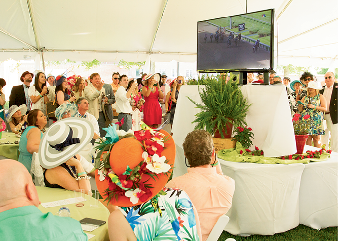 Attendees crowded around the big screen to watch the Kentucky Derby.
