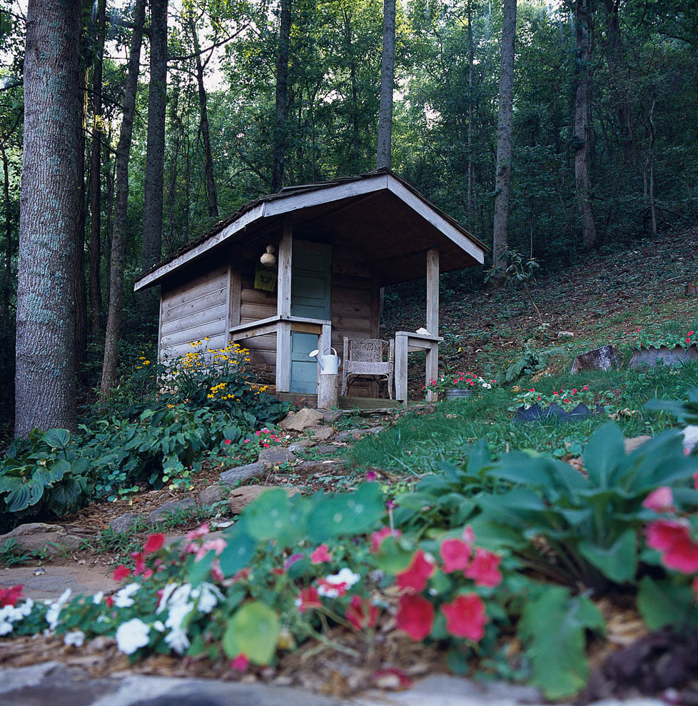 Chic Storage: A small log shed up the hill is used for garden storage.