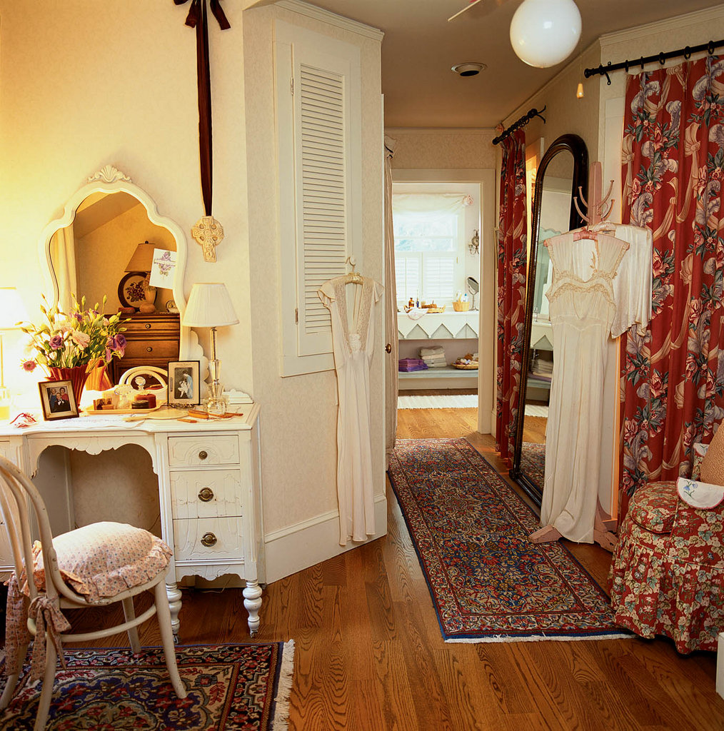 Vintage Glam: Long’s collection of early 20th-century dressing gowns hangs in the upstairs landing and hallway alongside vintage bark cloth curtains that disguise closet space.