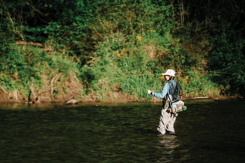 Headwaters Outfitters’ Lydia Dann fly casts for wild trout in the headwaters of the French Broad upstream from Rosman.