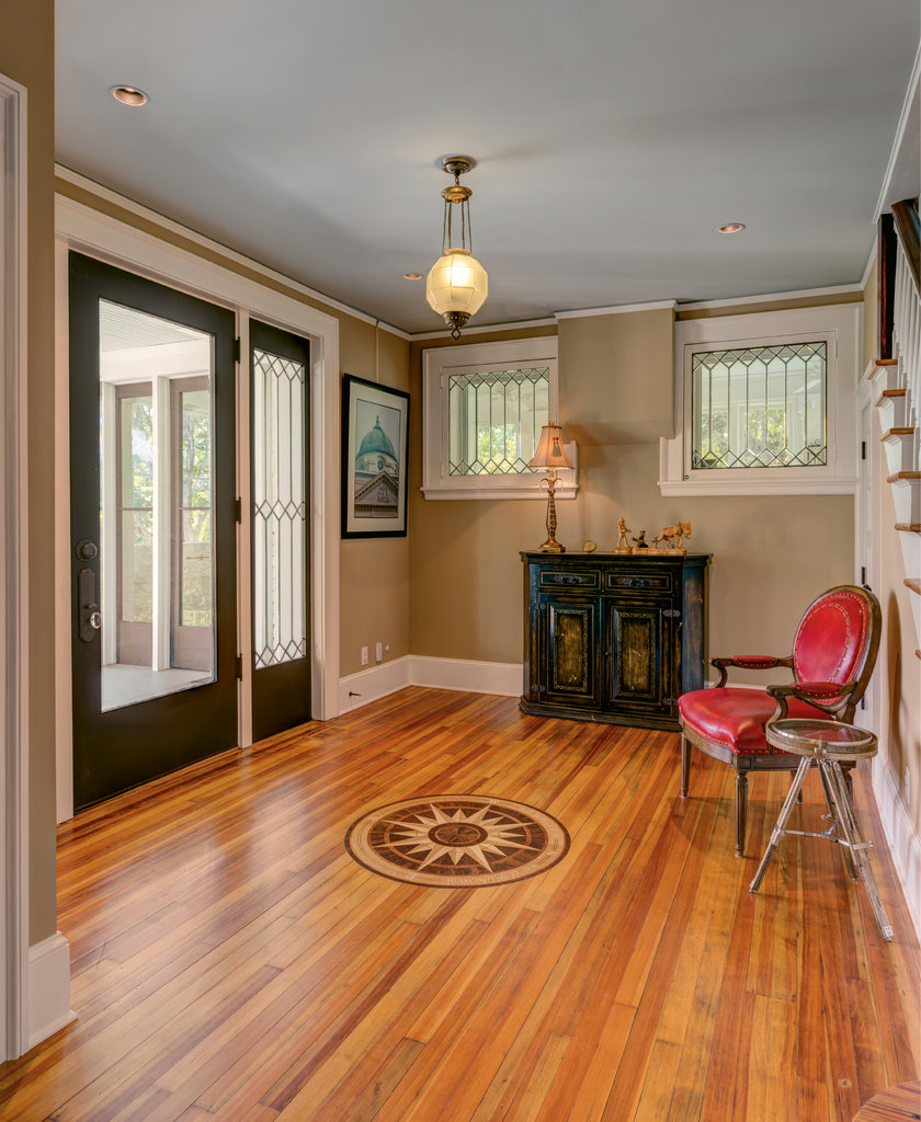 In the entry hall, bevel-leaded windows and an oversized door point to the dwelling’s early 1900s age, while the compass rose in the floor, which features the house’s coordinates, is a symbol of Cole and Carole Hedden’s commitment to their new forever home.