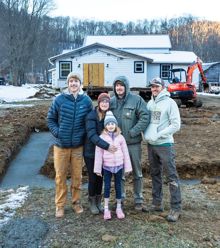 Lance Buskey stands with a local family,