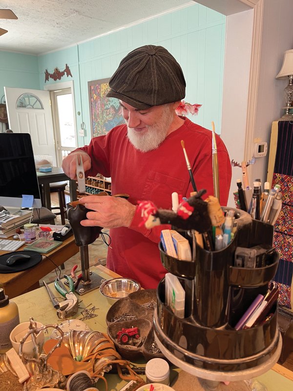 Robertson teaches cobbling to students of all ages inside her home studio. Above, one works on the sole using a shoehammer.