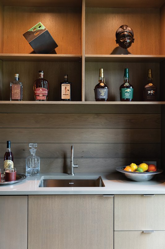 Behind the kitchen is a functional secondary prep space, complete with an additional dishwasher and other appliances, a wet bar, refridgerator drawers, and an ice maker.