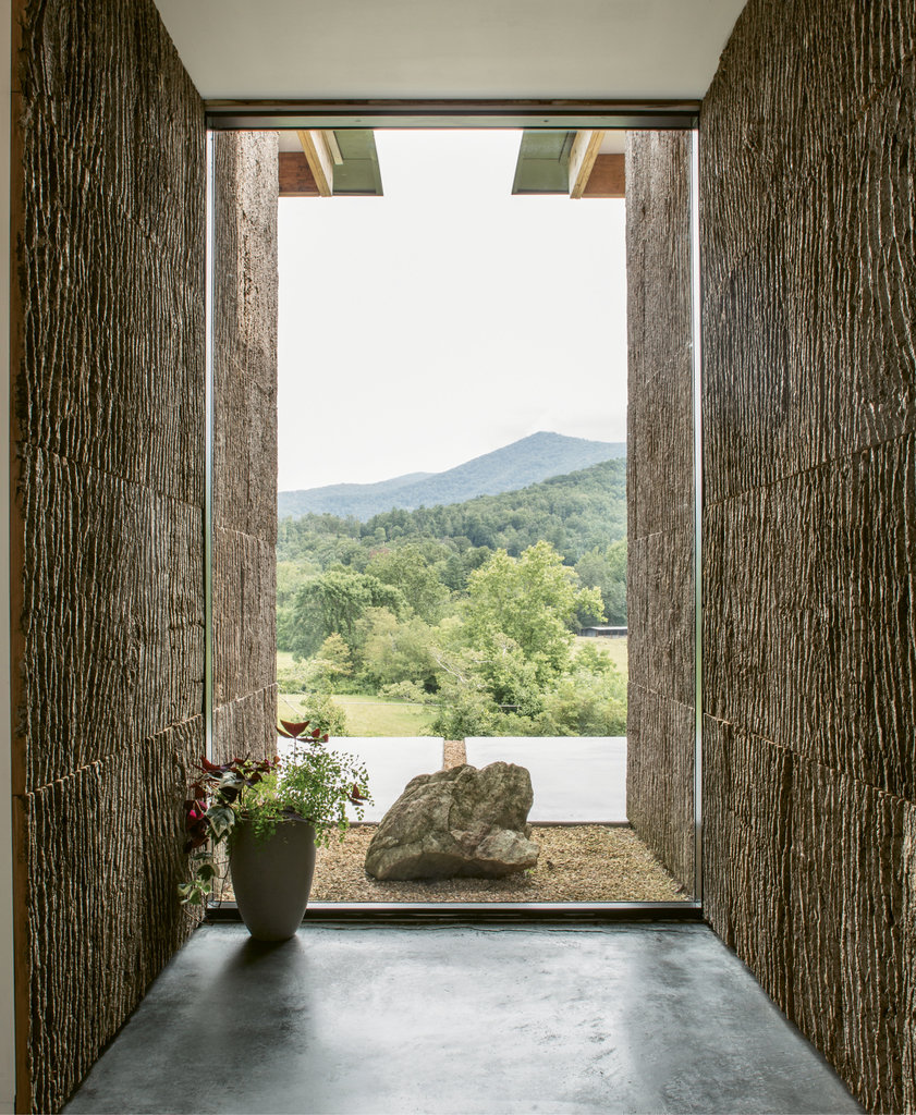 Zen Greeting: The entry, clad in bark harvested in Barnardsville, carries nature indoors and frames a spectacular view of peaks in the distance.