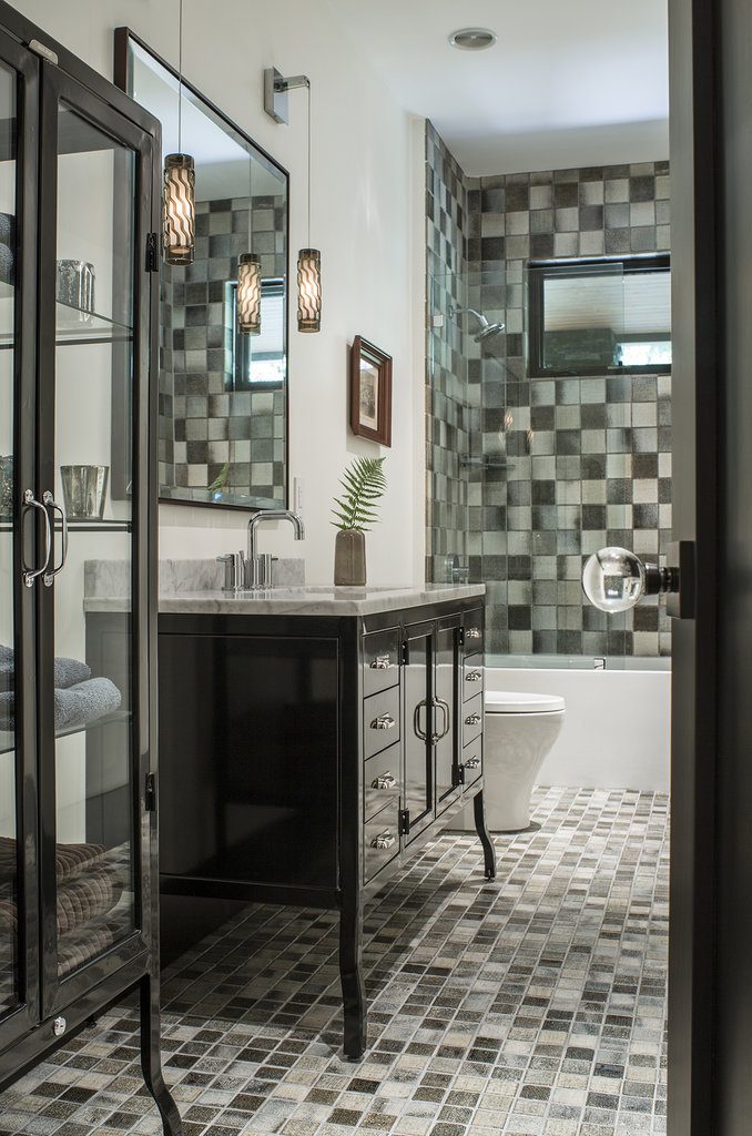 A downstairs guest bathroom features linen-textured handmade tiles from Japan.