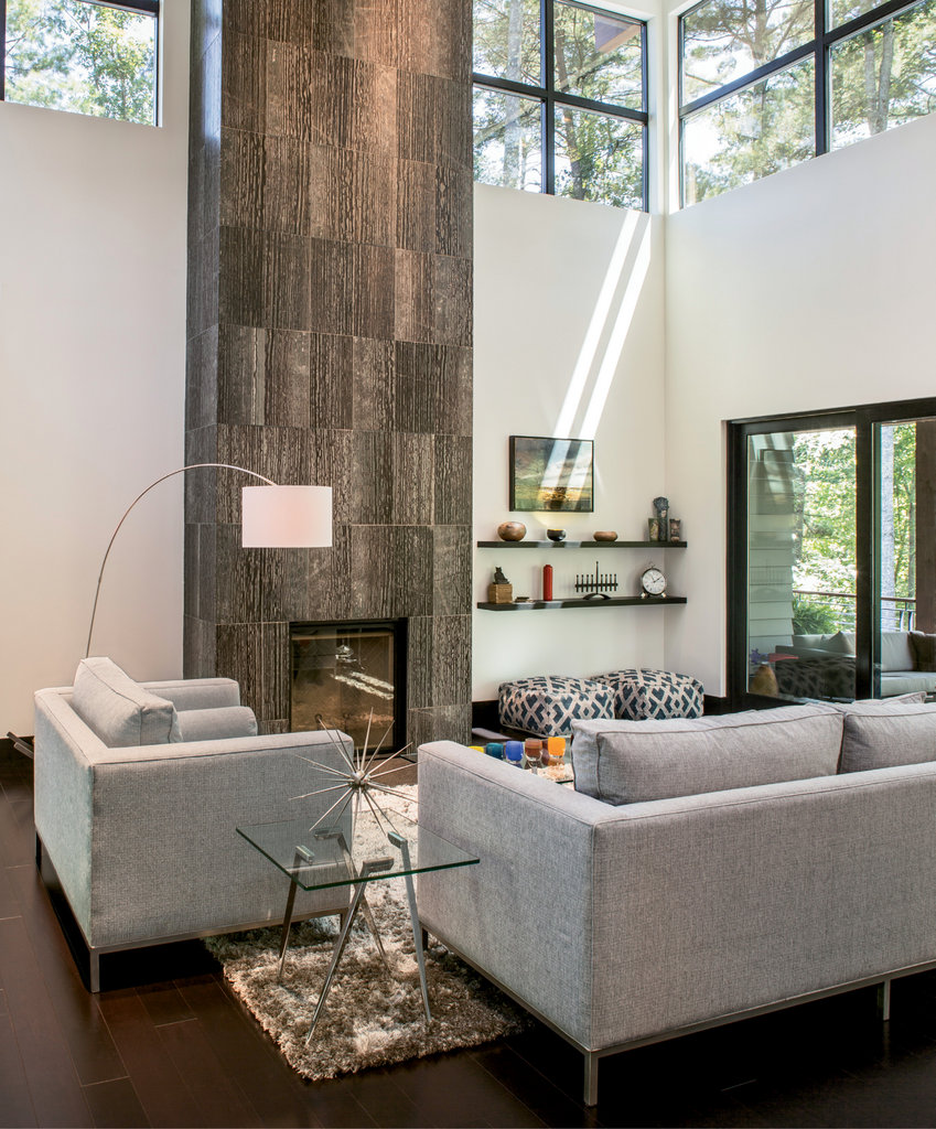 In the great room, clerestory windows allow in ample light. The floor-to-ceiling marble fireplace and inviting views through large sliding glass doors vie for attention.