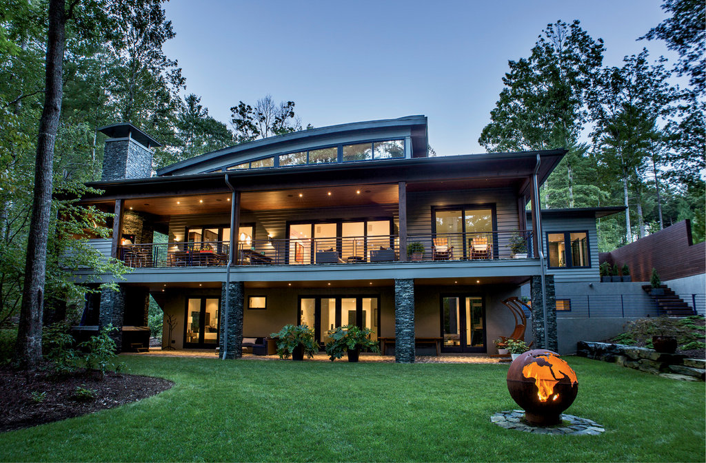 A metal Earth fire pit draws guests outside, while 1,575 square feet of covered porch and patio hold an outdoor kitchen, ample seating areas, and a hot tub.