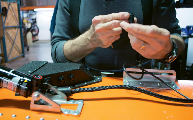 Carl Mersch assembles a connector.