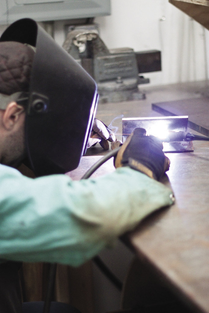 After bending the paper into intriguing forms, he welds metal components to cradle the shapes