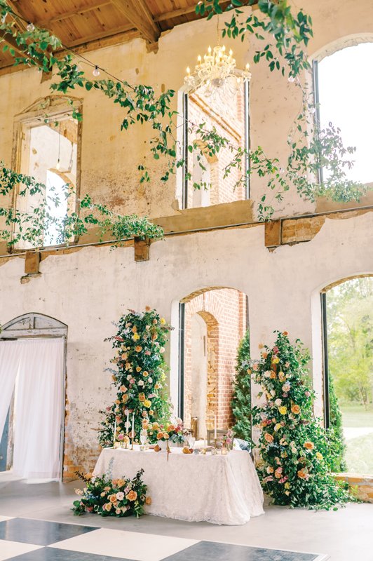 View of the sweetheart table lush with florals.