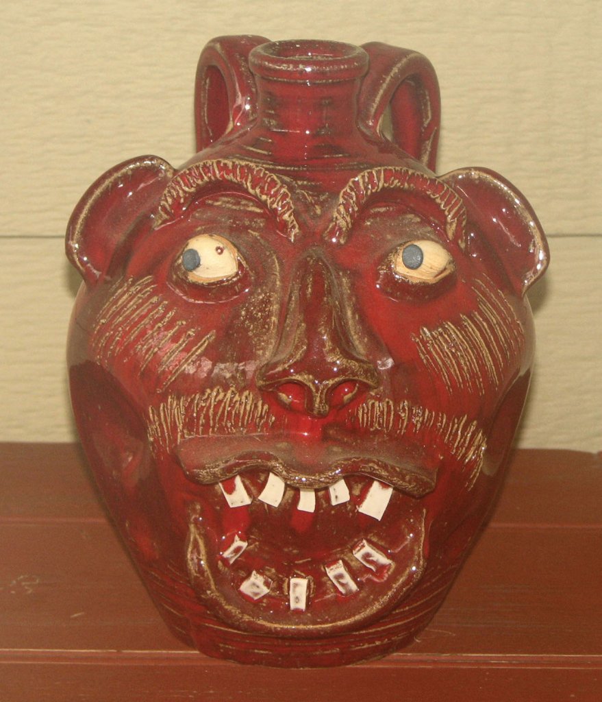 Charles Lisk, a Catawba potter known for multicolor alkaline glazes and close ties to Burlon Craig, made this unique face jug. Courtesy of wiki.