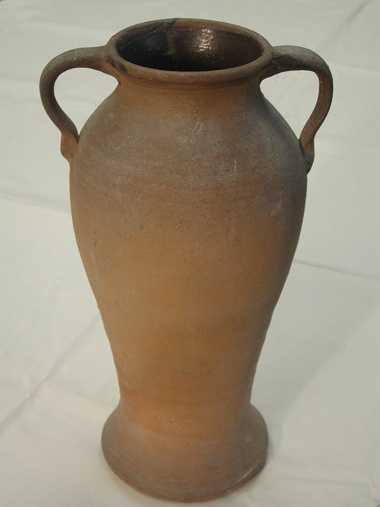 This handled vase features a bare exterior, yet is coated in an Albany Slip on the inside. Likely from Buncombe County.