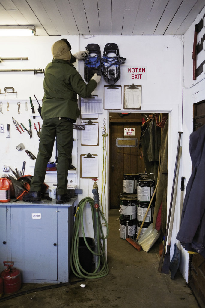 Matthew Brown reaches for the  essential gear of winter: snowshoes.